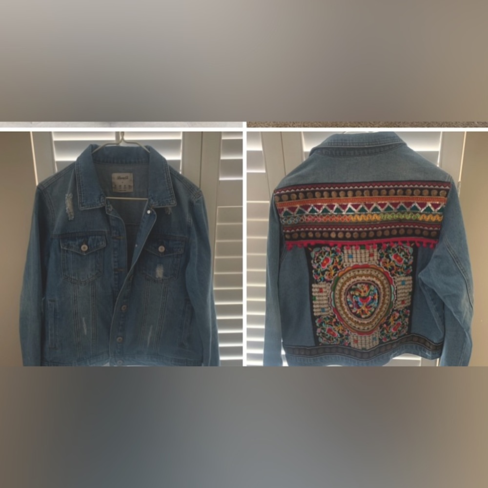 Women’s Jean jacket with colorful appliqué on back.